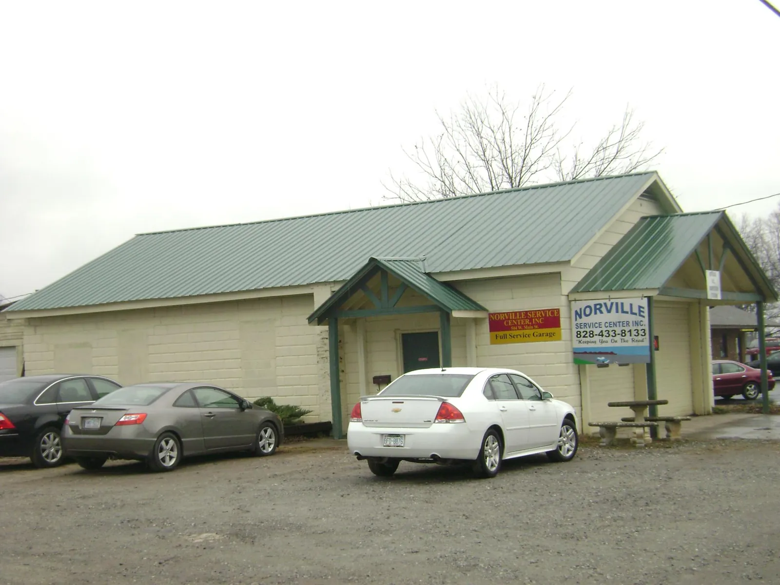 Green metal roof on a service garage with a covered entry in Charleston